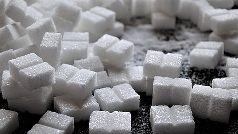 Close-up view of stacked white sugar cubes.