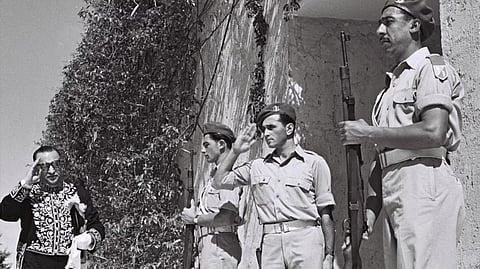 Iranian diplomat Reza Saffinia salutes Israeli soldiers as he enters the residence of Israel’s first president [RFE/RL]