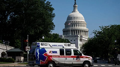 An ambulance drives by the U.S. Capitol on June 28. [KffHralthNews]