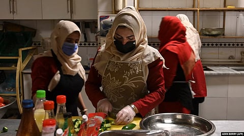 Survivors of domestic violence are seen cooking at a restaurant in Kabul established by Mary Akrami, founder of a shelter and a restaurant where women lived and work