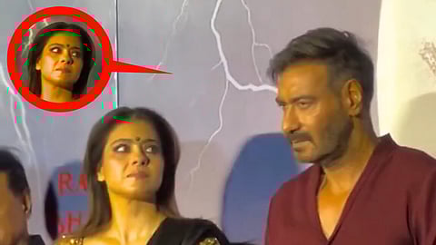 Kajol giving a side-eye glance to Ajay Devgn during an event.