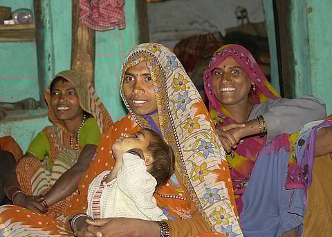 in the image a mother is shown with her daughter and lack of infrastructure is shown