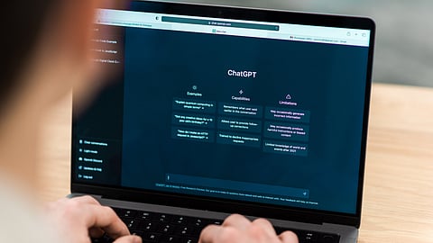 man using chatgpt on laptop