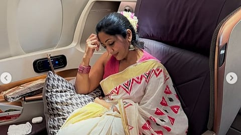 Actress Navya Nair with the jasmine flower garland on her flight to Australia for Onam celebration