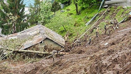 The rescuers constructed a makeshift tree-log bridge across the flooded Hume River to reach the trapped victims.