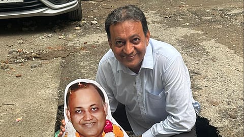 Monty standing in a pothole with a cutout of himself