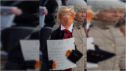 Protesters hold signs and flags and a large balloon with an image of US President Donald Trump during the nationwide “Hands Off!” protest against Trump and his adviser, Tesla CEO Elon Musk, in downtown Los Angeles on April 5, 2025.