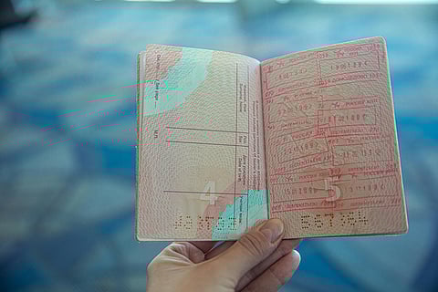 Image of a person holding a passport