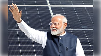  Gandhinagar: Prime Minister Narendra Modi waves to the people as he visits the residence of the beneficiaries of the PM Surya Ghar Free Electricity Yojana in Gandhinagar on Wednesday, September 18, 2024.
