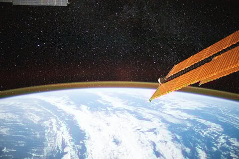 Image of long-exposure picture  from the International space station showing the Milky Way above the atmosphere of Earth
