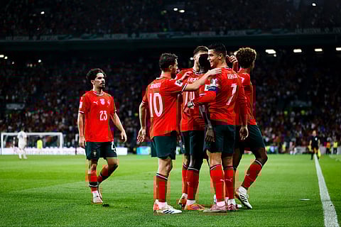 Cristiano ronaldo with his team in the football field celebrating his goal and new world record