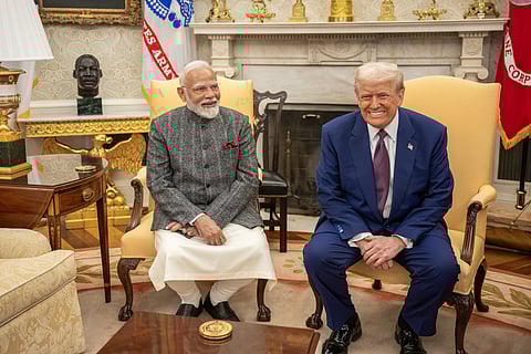 Image of President Trump and PM Modi smiling and sitting at the white House. 