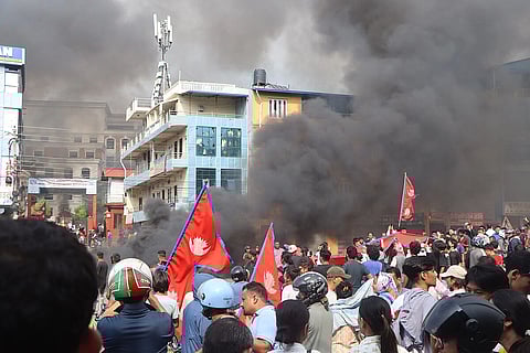 Black smoke is everywhere because of fire and fights during the Nepal Gen Z protest many young protesters are there wearing helmets and some bear headed with Nepal flag in their hands