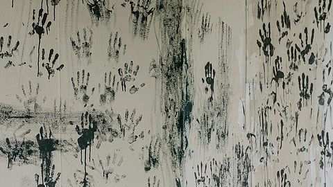 Hand prints with black colour in the wall representing ghost or supernatural