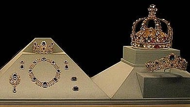 Image of crowns and other jwellery. The image is screaming royalty. 