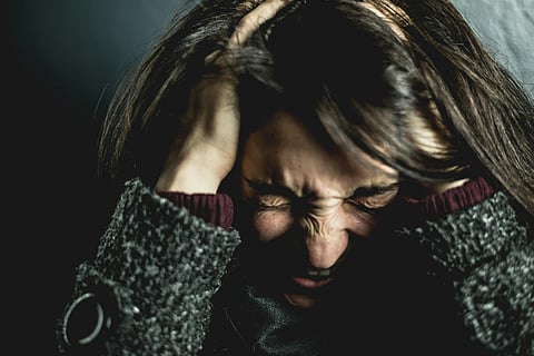 A girl with her hand in her hair is looking stressfull pulling her hair in stress