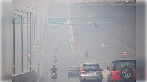 A vehicle navigates a congested highway, illustrating the impact of traffic-related pollution.