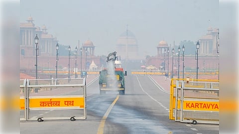 New Delhi: A New Delhi Municipal Council (NDMC) anti-smog gun sprays water to curb air pollution at Kartavya Path in New Delhi on Tuesday, October 21, 2025