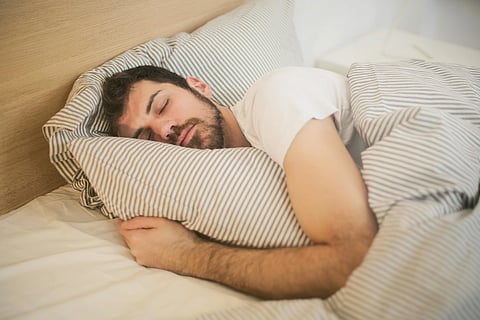 A man in lying in his bed sleeping soundly