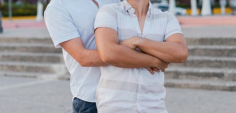 image of two men hugging each other in white t shirts 