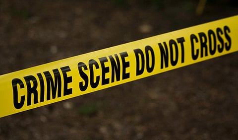 Image of a crime scene barrier with do not cross written on it.