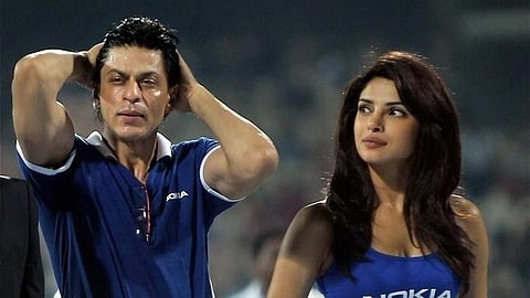 In the image Shah Rukh Khan and Priyanka Chopra in stadium both wearing Nokia merchandise
