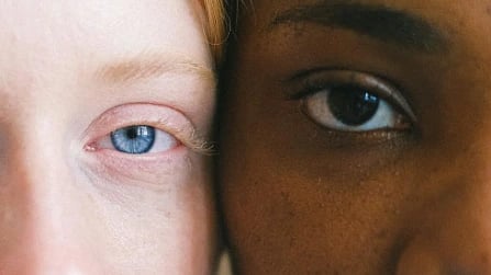 Close up shot of eyes of two different people standing close to each other.