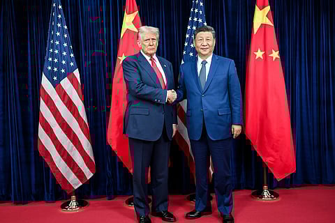 Donald Trump and Xi Jinping shaking hands while meeting in South Korea, 2025.