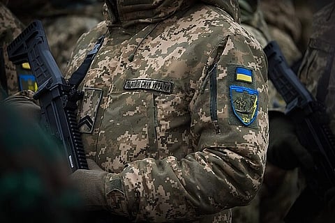 In the image Ukraine soldier is shown in his uniform and batch only uniform and batch is visible