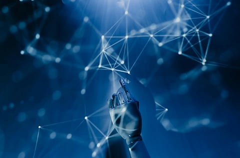 Image Depicting Artificial Intelligence by showing a robot hand pointing towards a wall. 