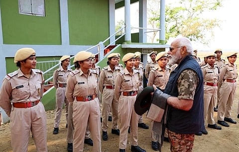 In the image PM Modi is shown with the women guards of kaziranga national park India