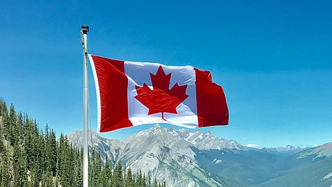 In the image canada map is shown hoisted in the sky flowing with the wind