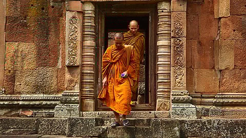 Two Monk in Orange Robe Walking Down the Concrete Stairs in Thailand. 
