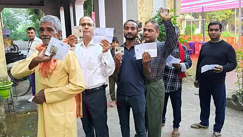 Voters standing in a queue at a polling station in Bihar early morning of November 6, 2025 during the first phase of the Assembly elections.