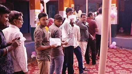 In the image voters are shown giving votes in Bihar Polls