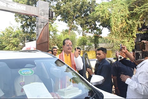 In the image the Deputy CM Vijay Sinha is shown going inside his car 