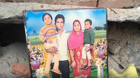 The portrait of the family that was killed in the roof collapse incident in Patna. There are two kids and the parents in the photo frame. 