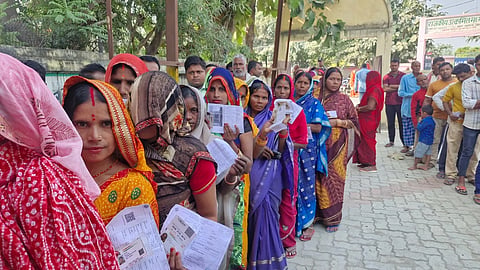 Women standing in line to vote at a booth in West Champaran