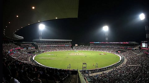 The stadium Eden Garden of Kolkata. The green ground and pitch is visible with crowd surrounding the stand to witness the match. 