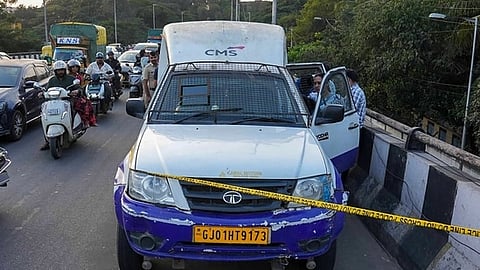 A photo of the CMS van with police tape in front of it and investigators at the scene.