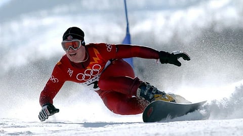 Former Olympic snowboarder Ryan Wedding doing snowboarding, dressed in red uniform when playing at the Olympics.