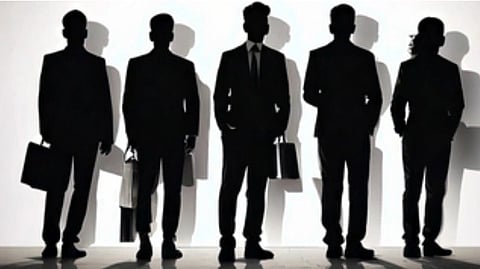 Five silhouetted men in suits hold briefcases, casting shadows on a wall. The scene conveys professionalism and teamwork in a corporate setting.