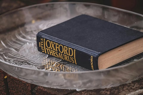Hardcover Oxford Thesaurus book on a glass plate