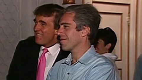 Old Image of Donald trump and Jeffrey Epstein. Trump is wearing a suit with pink tie and Epstein is wearing his blue shirt, Both are looking at someone and smiling.