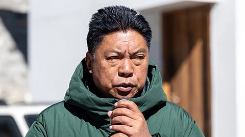 Arunachal CM Pema Khandu giving a speech in a green jacket.