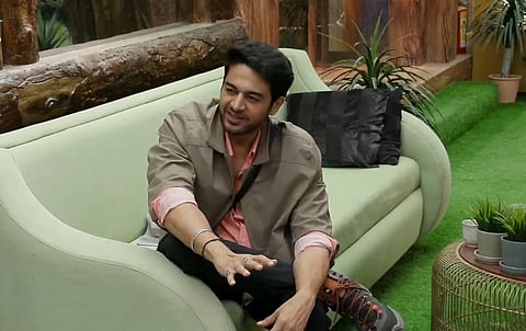 Actor Gaurav Khanna in a floral suit joyfully holds a "Bigg Boss 19 Winner" trophy after winning the title.