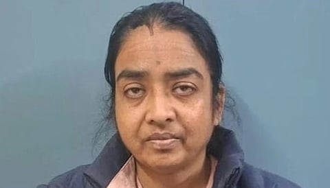 A women looking at the camera. She is looking dull with half eyes open wearing a dark blue jacket