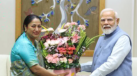 Rekha Gupta meets Narendra Modi at the PM Office. They exchange a bouquet of flowers.
