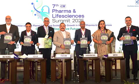 Minster Jitendra Singh with six other individuals holding reports at the Confederation of Indian Industry (CII) Pharma & Life Sciences Summit 2025.