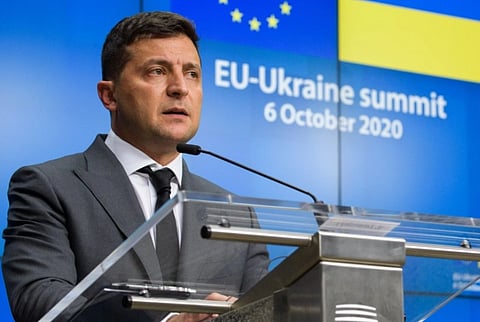 Volodymyr Zelenskyy, speaks at a podium during the EU-Ukraine Summit on October 6, 2020. Background shows EU and Ukrainian flags, conveying a formal tone.